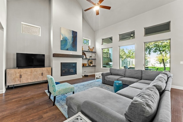 living room with ceiling fan, dark hardwood / wood-style floors, and high vaulted ceiling