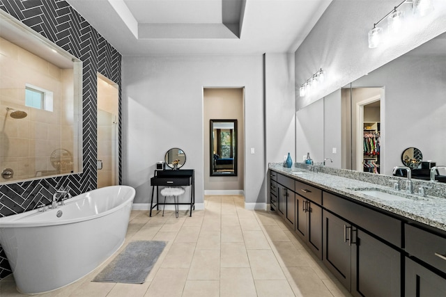 bathroom featuring tile patterned floors, independent shower and bath, and vanity