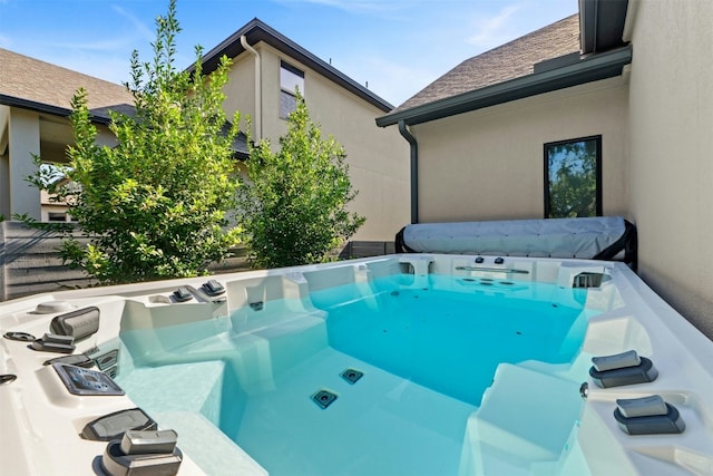 view of pool with a hot tub