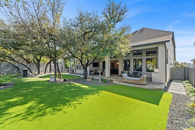 back of house featuring a yard, outdoor lounge area, a patio, and ceiling fan