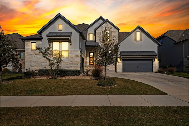 view of front of property featuring a lawn and a garage