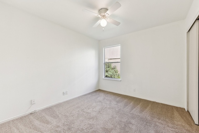 unfurnished bedroom featuring ceiling fan, light carpet, and a closet