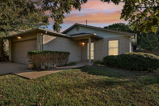 view of front facade with a lawn and a garage