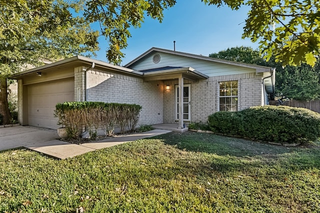 ranch-style home featuring a front lawn and a garage