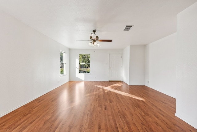 empty room featuring ceiling fan and hardwood / wood-style floors