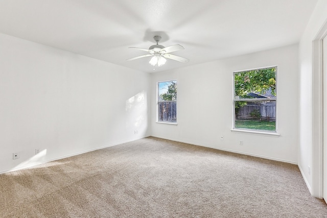 carpeted empty room with ceiling fan