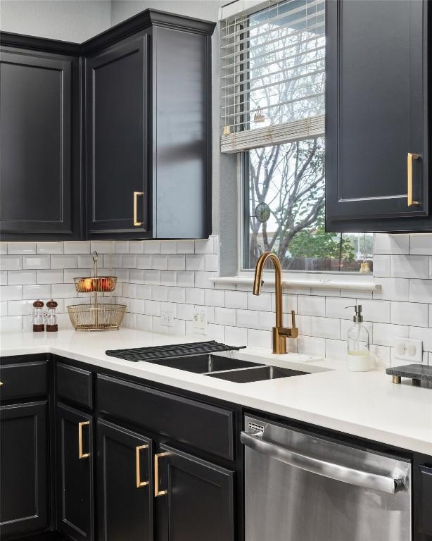 kitchen featuring backsplash, dishwasher, and sink