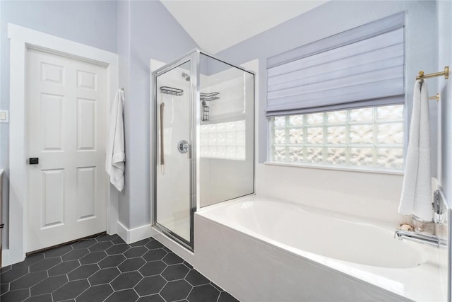 bathroom featuring shower with separate bathtub