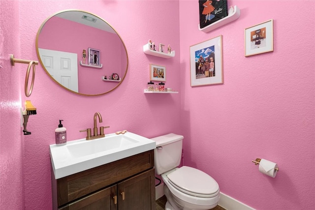 bathroom with toilet and vanity