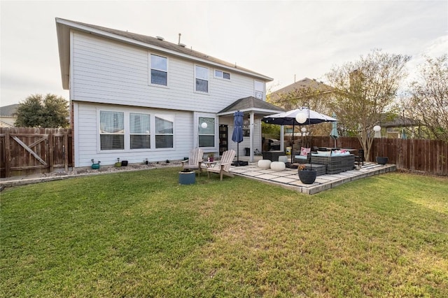 rear view of property featuring an outdoor hangout area, a yard, and a patio