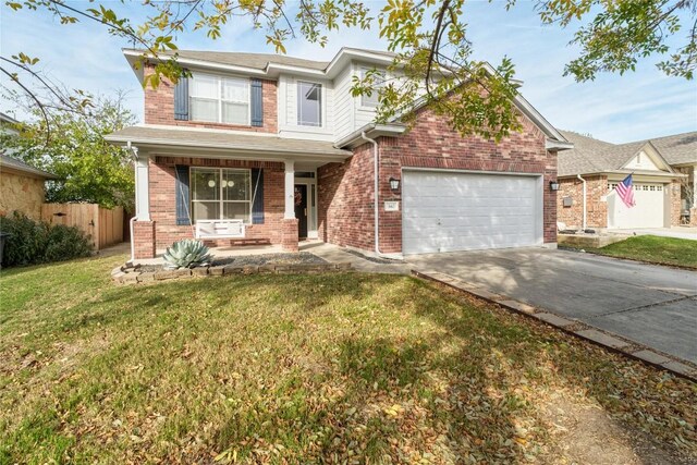 view of front of house featuring a garage, a porch, and a front yard