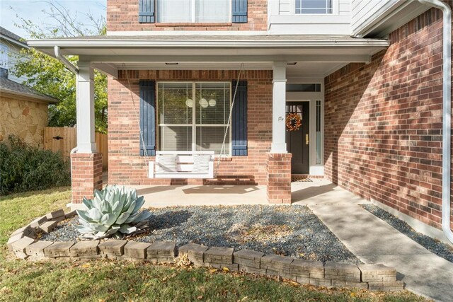 property entrance with covered porch