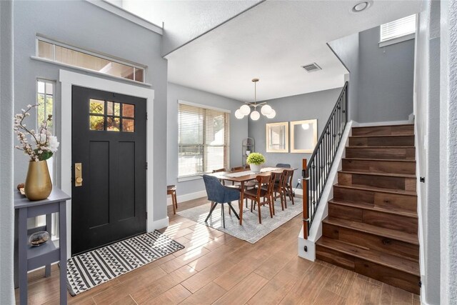 foyer featuring plenty of natural light and an inviting chandelier