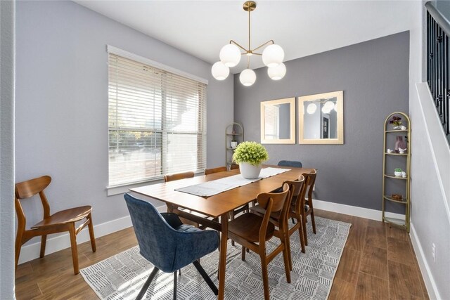 dining space featuring dark hardwood / wood-style flooring and a notable chandelier