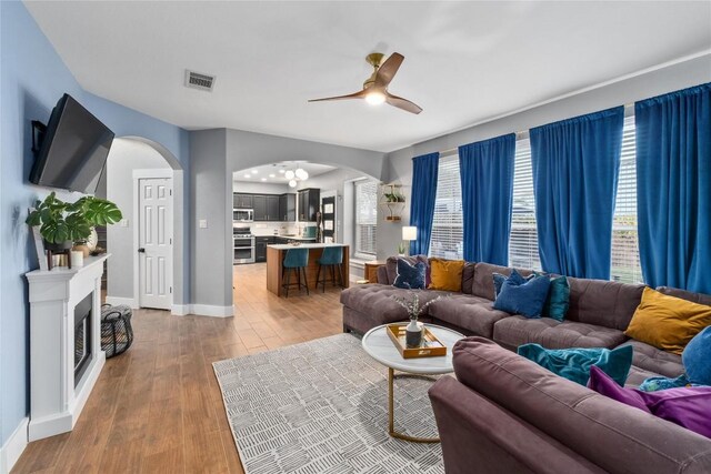 living room with ceiling fan and light hardwood / wood-style floors