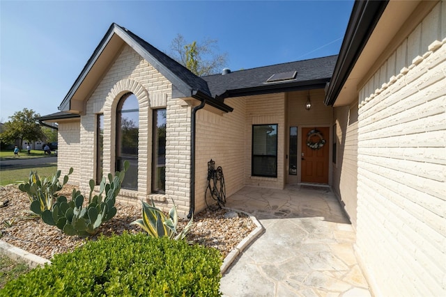 view of exterior entry featuring a patio