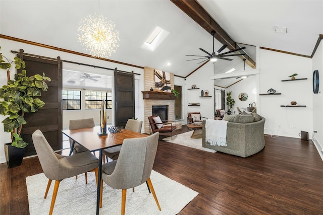 dining space with a barn door, dark hardwood / wood-style flooring, lofted ceiling with beams, and a fireplace