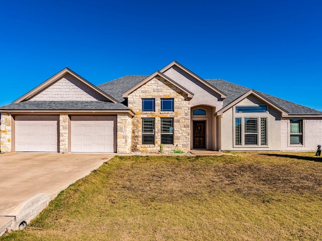 view of front of house with a front lawn and a garage