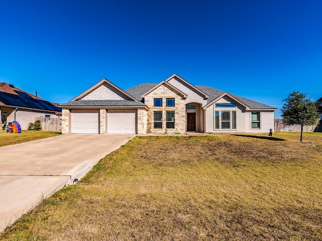 view of front of home with a front yard and a garage