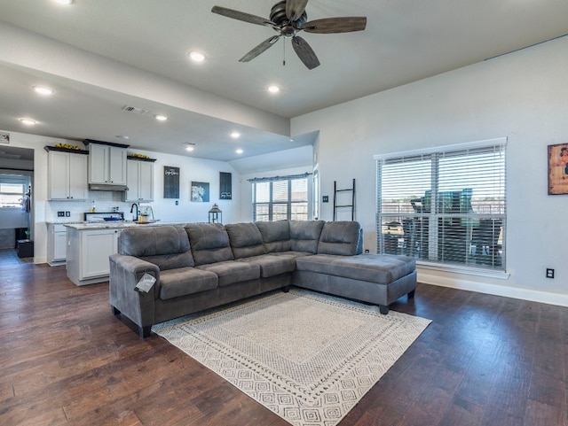 living room featuring ceiling fan and dark wood-type flooring