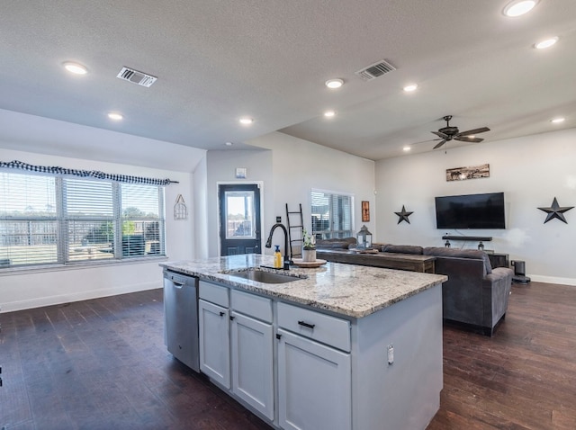 kitchen featuring dishwasher, sink, dark wood-type flooring, and a center island with sink