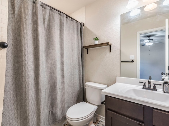 bathroom featuring curtained shower, ceiling fan, vanity, and toilet