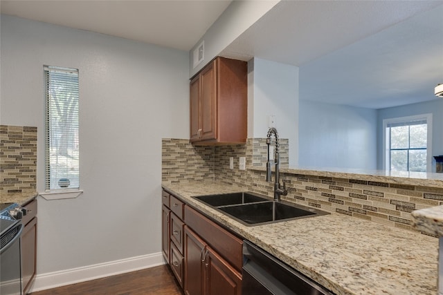 kitchen featuring appliances with stainless steel finishes, backsplash, dark hardwood / wood-style floors, and sink