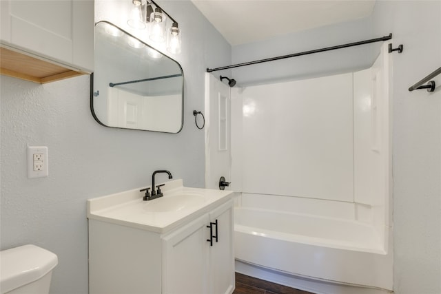 full bathroom featuring hardwood / wood-style flooring, vanity, shower / bathtub combination, and toilet