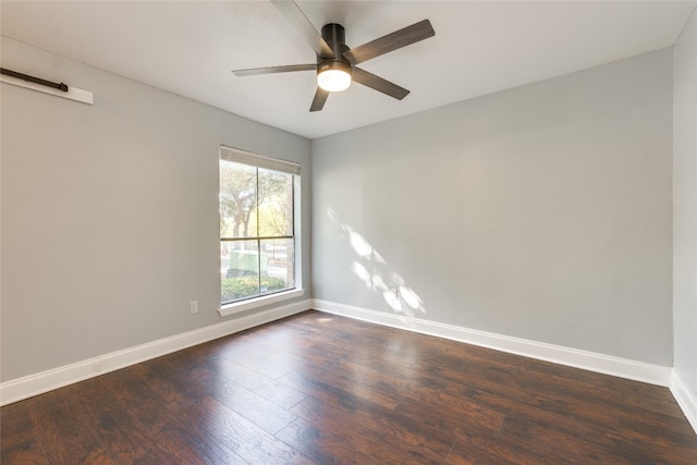 empty room featuring ceiling fan and dark hardwood / wood-style flooring