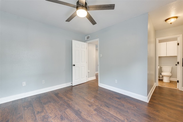 spare room with dark hardwood / wood-style floors and ceiling fan