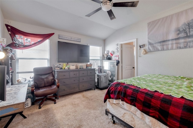 carpeted bedroom with ceiling fan and vaulted ceiling