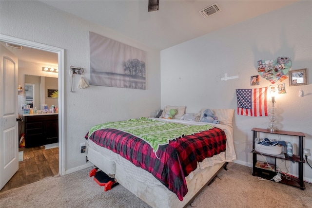 carpeted bedroom with ensuite bath