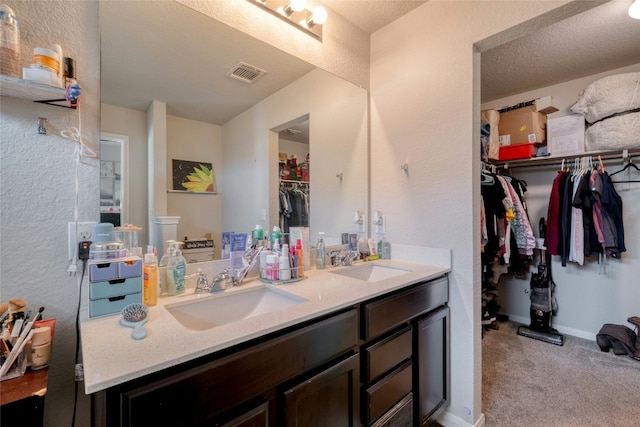 bathroom featuring vanity and a textured ceiling