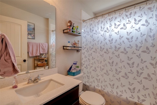 full bathroom featuring vanity, shower / bath combination with curtain, and toilet