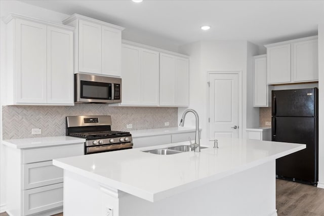 kitchen with white cabinets, sink, an island with sink, and appliances with stainless steel finishes