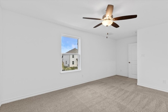 empty room featuring light carpet and ceiling fan