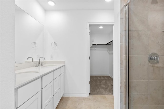 bathroom with tile patterned flooring, vanity, and an enclosed shower