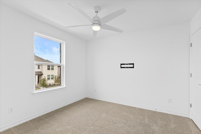 empty room with carpet flooring, plenty of natural light, and ceiling fan