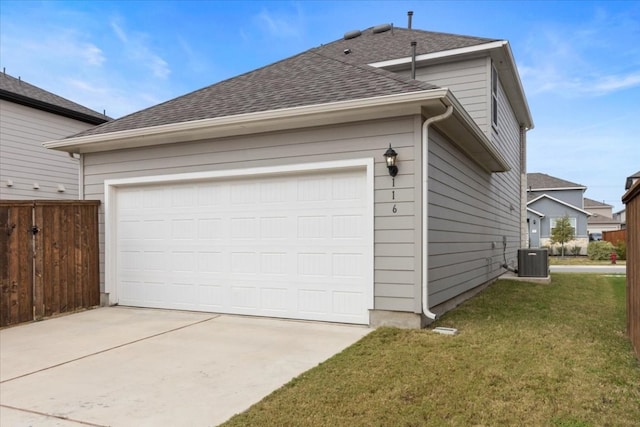 garage featuring cooling unit and a lawn