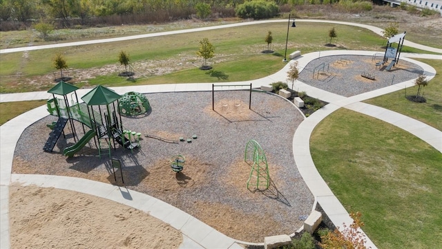 view of home's community featuring a lawn and a playground