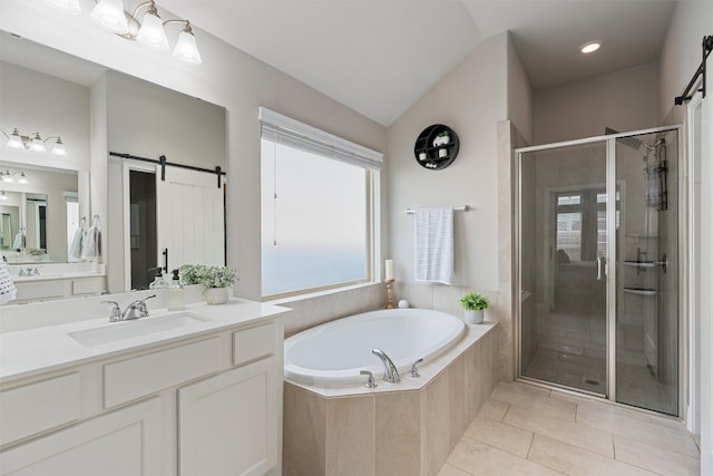 bathroom featuring tile patterned flooring, vanity, lofted ceiling, and independent shower and bath