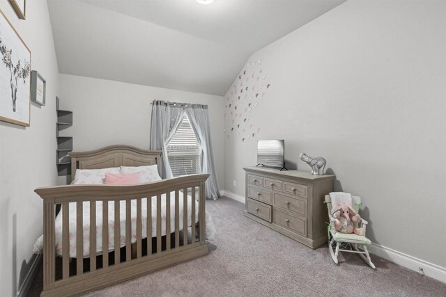 carpeted bedroom with vaulted ceiling