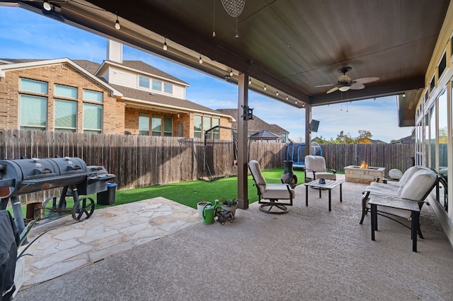 view of patio / terrace with an outdoor fire pit and ceiling fan