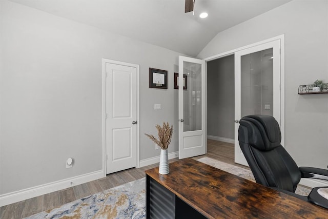 office space featuring french doors, ceiling fan, light hardwood / wood-style floors, and vaulted ceiling