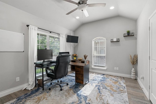 home office with ceiling fan, lofted ceiling, and light wood-type flooring