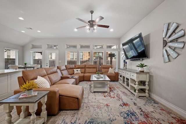 living room featuring ceiling fan and lofted ceiling