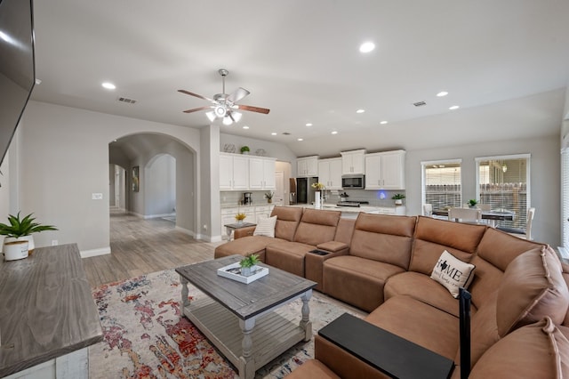 living room featuring ceiling fan and light hardwood / wood-style flooring