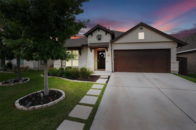 view of front of house with a garage and a lawn