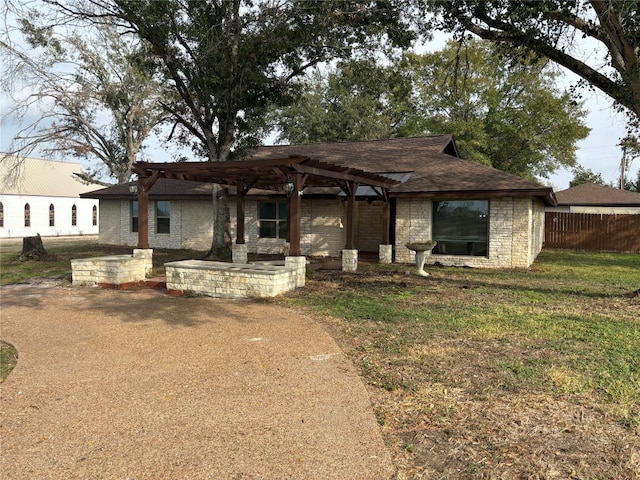 view of front of house with a pergola and a front yard