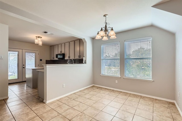 kitchen with french doors, hanging light fixtures, a notable chandelier, kitchen peninsula, and light tile patterned flooring